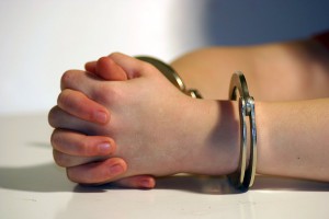 Child's hands in handcuffs