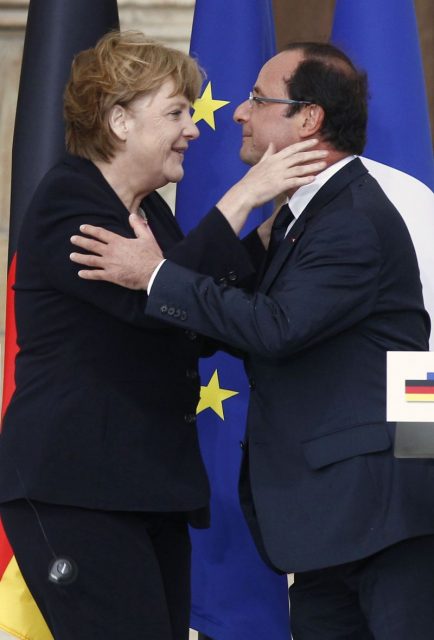 France's President Hollande and German Chancellor Merkel kiss each other after their speeches during the 50th anniversary ceremony of a reconciliation meeting in Reims