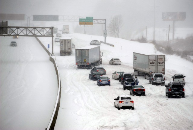 Stalled vehicles are seen during a blizzard as traffic comes to a standstill on the I-635 in Kansas City