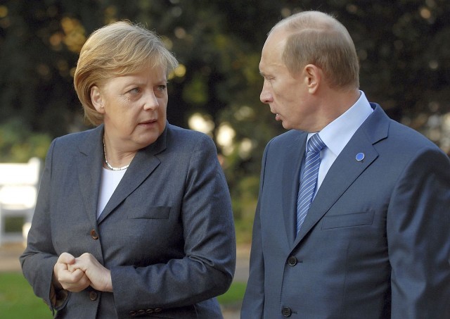 Russia's President Putin talks to German Chancellor Merkel at the Kurhaus resort garden in Wiesbaden