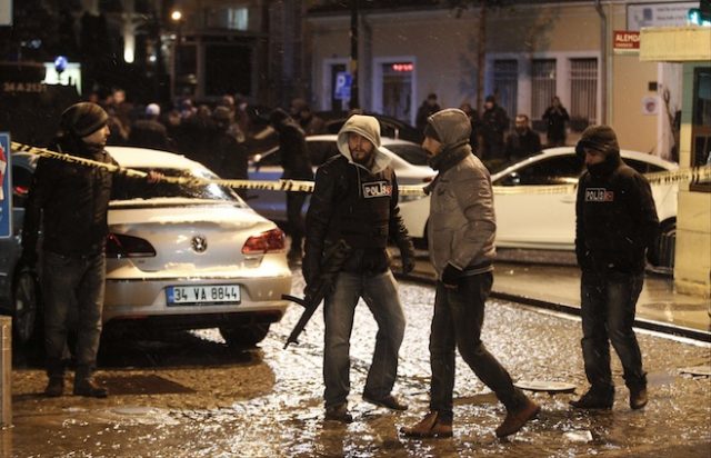 Police officers stand guard at the scene of a bomb blast in Istanbul