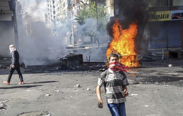 Kurdish protestors clash with Turkish riot policemen in  Diyarbakir on October 8, 2014. The Turkish army has deployed in the streets of Diyarbakir to impose a curfew, following violent protests by pro-Kurdish demonstrators in southeast Turkey angry at the government's lack of action against jihadists in Syria, officials said on October 8, 2014. At least 14 people were killed, 8 of the deaths came in Turkey's main Kurdish city of Diyarbakir where the most intense rioting took place overnight. AFP PHOTO/ILYAS AKENGINILYAS AKENGIN/AFP/Getty Images ** OUTS - ELSENT, FPG - OUTS * NM, PH, VA if sourced by CT, LA or MoD **